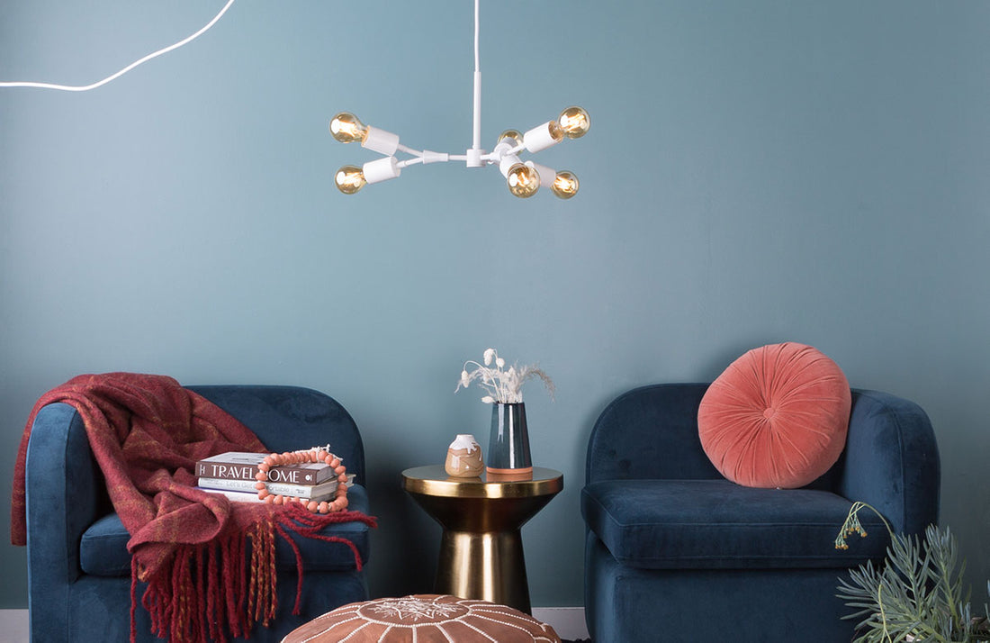 blue-accented dining room with large light fixture