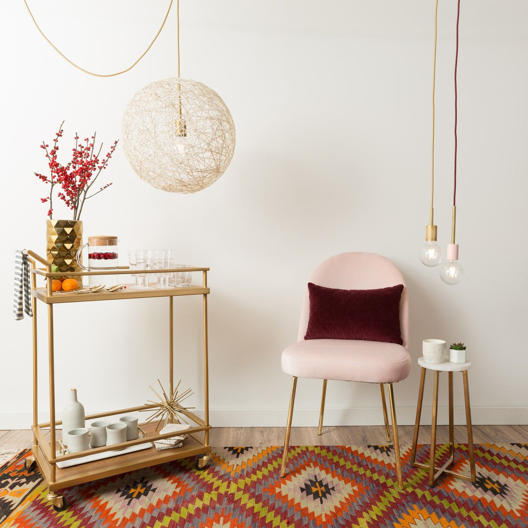 DIY String Ball chandelier by Color Cord Company hanging over a bar cart
