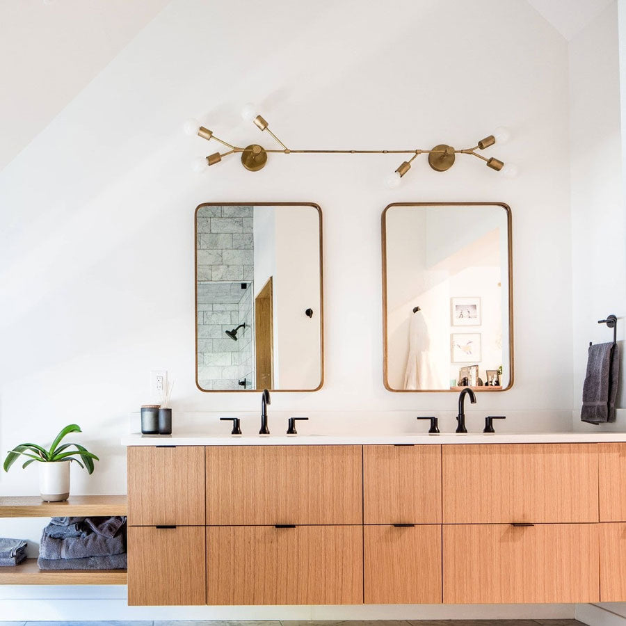 Image of a bathroom vanity with the Twig Sconce light sconce customized with j-box connections over two mirrors