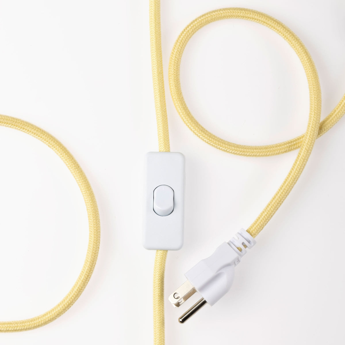 Close-up of a Fleur plug-in pendant's fluted raw porcelain shade with Pale Yellow cord
