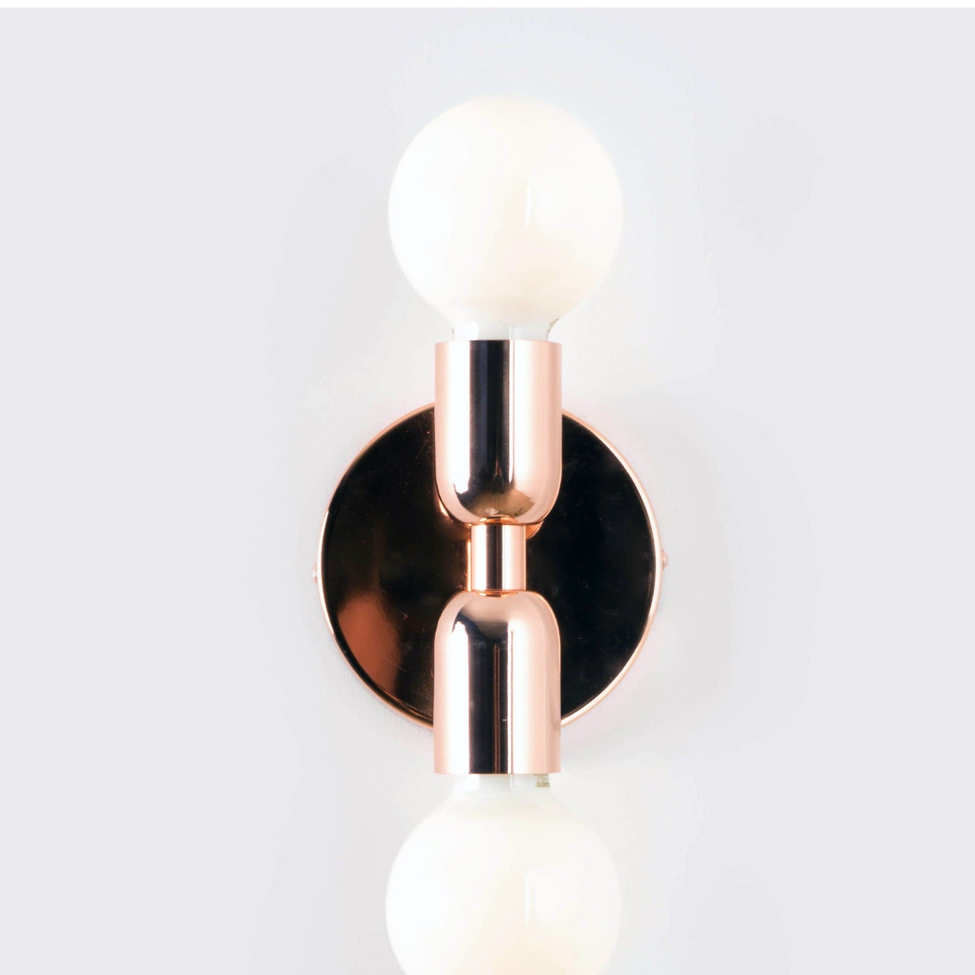 Junction Mini Duo Plug-In Sconce in Polished Copper Finish. View from straight on angle