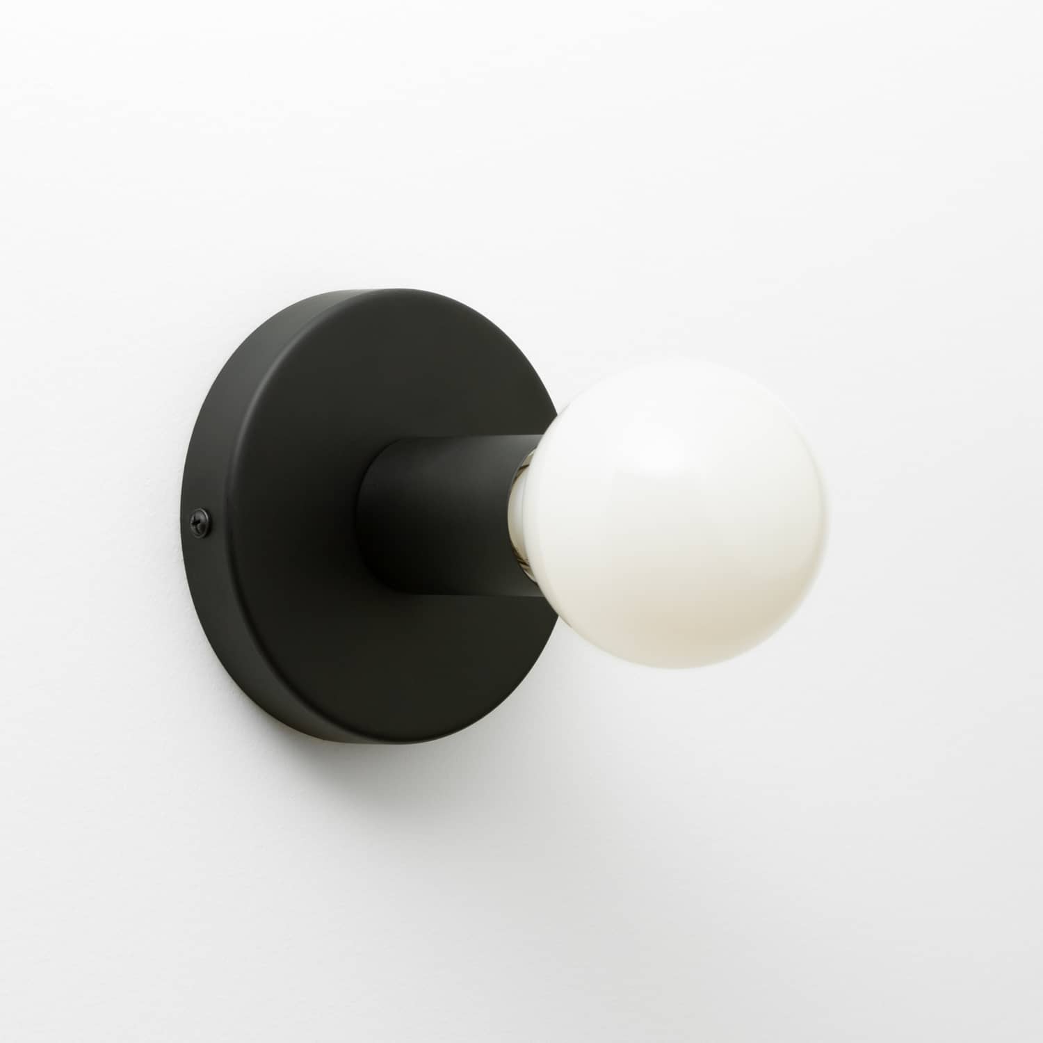 Button Light in Matte Black finish pictured with G25 milk glass light bulb