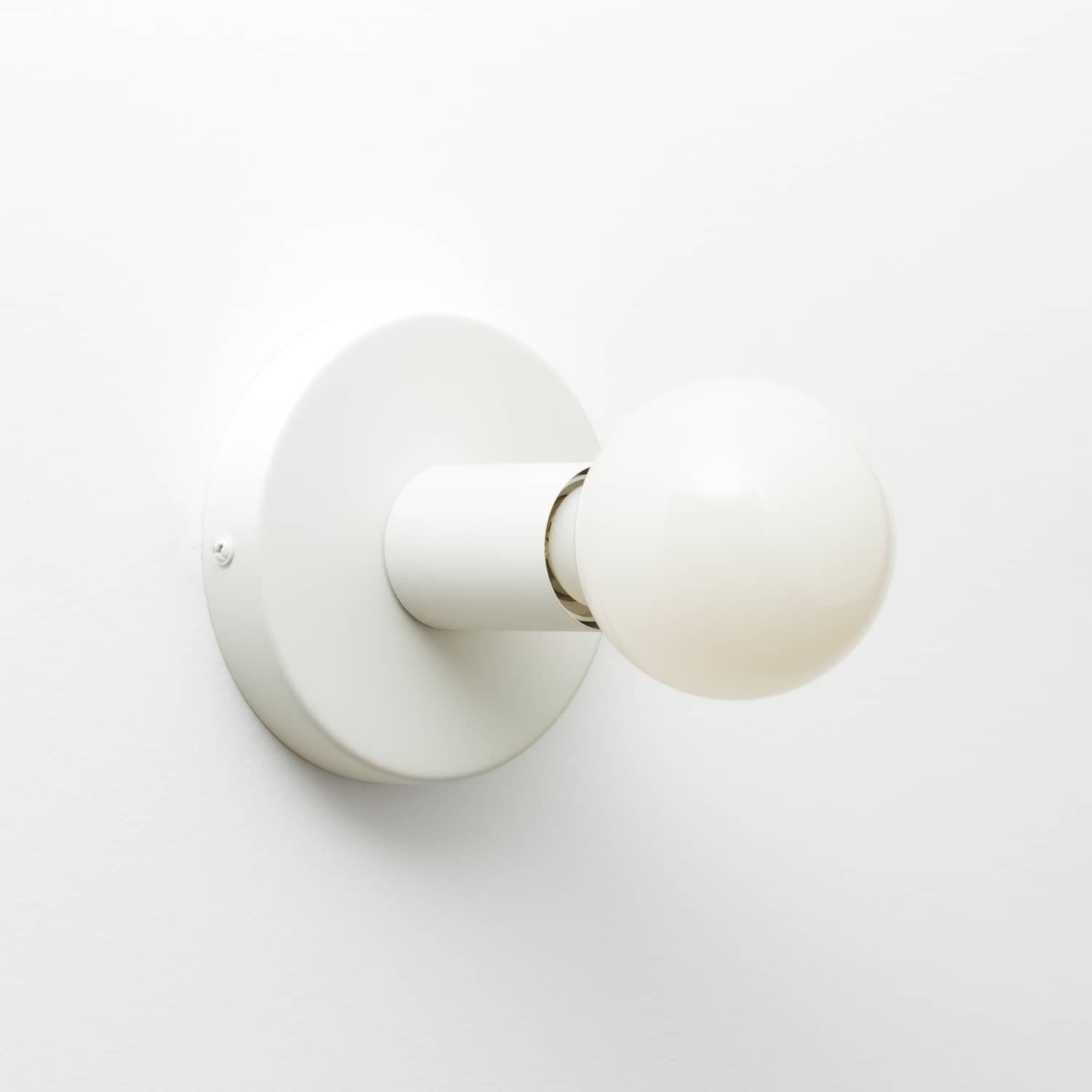 Button Light in Matte White finish pictured with G25 milk glass light bulb