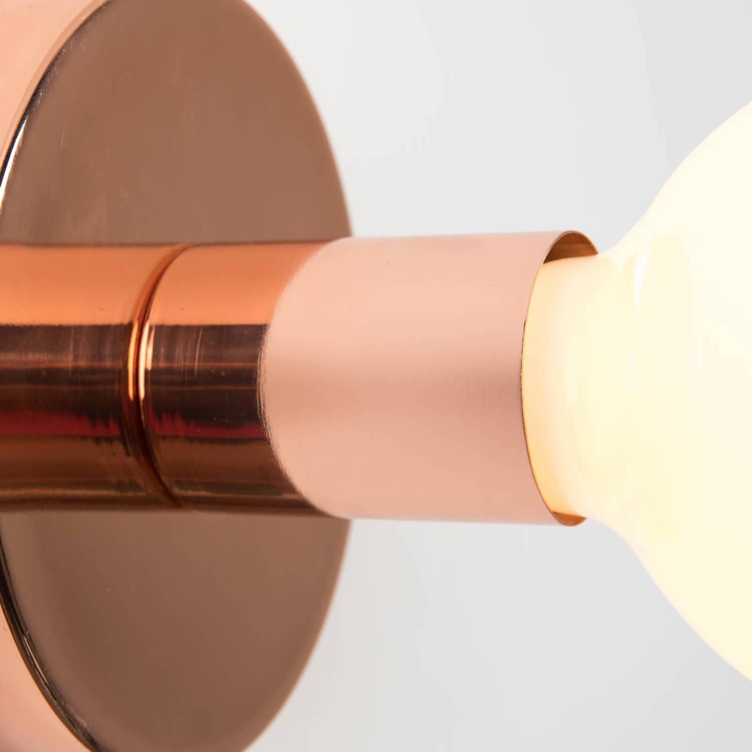 detail photo Button Plug-In Sconce in Raw Brass finish with G40 bulb.