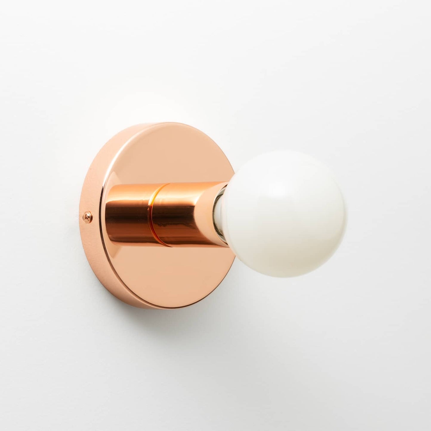 Button Light in Polished Copper finish pictured with G25 milk glass light bulb