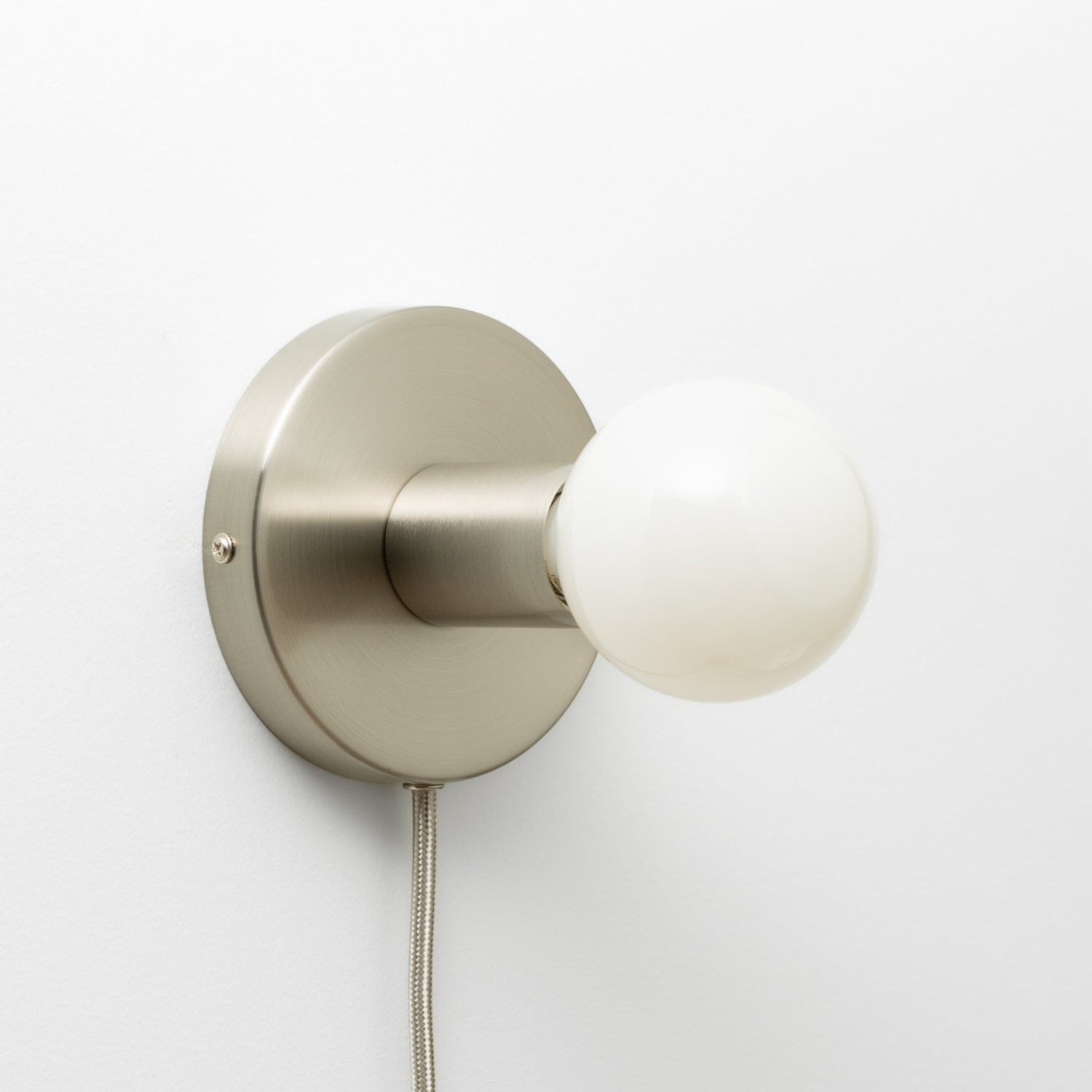 Button Plug-In Sconce in Brushed Nickel finish with G25 light bulb