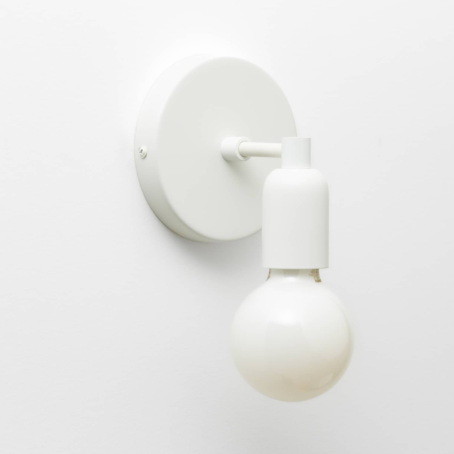 Junction Mini Solo Sconce in Matte White finish pictured with a G25 light bulb