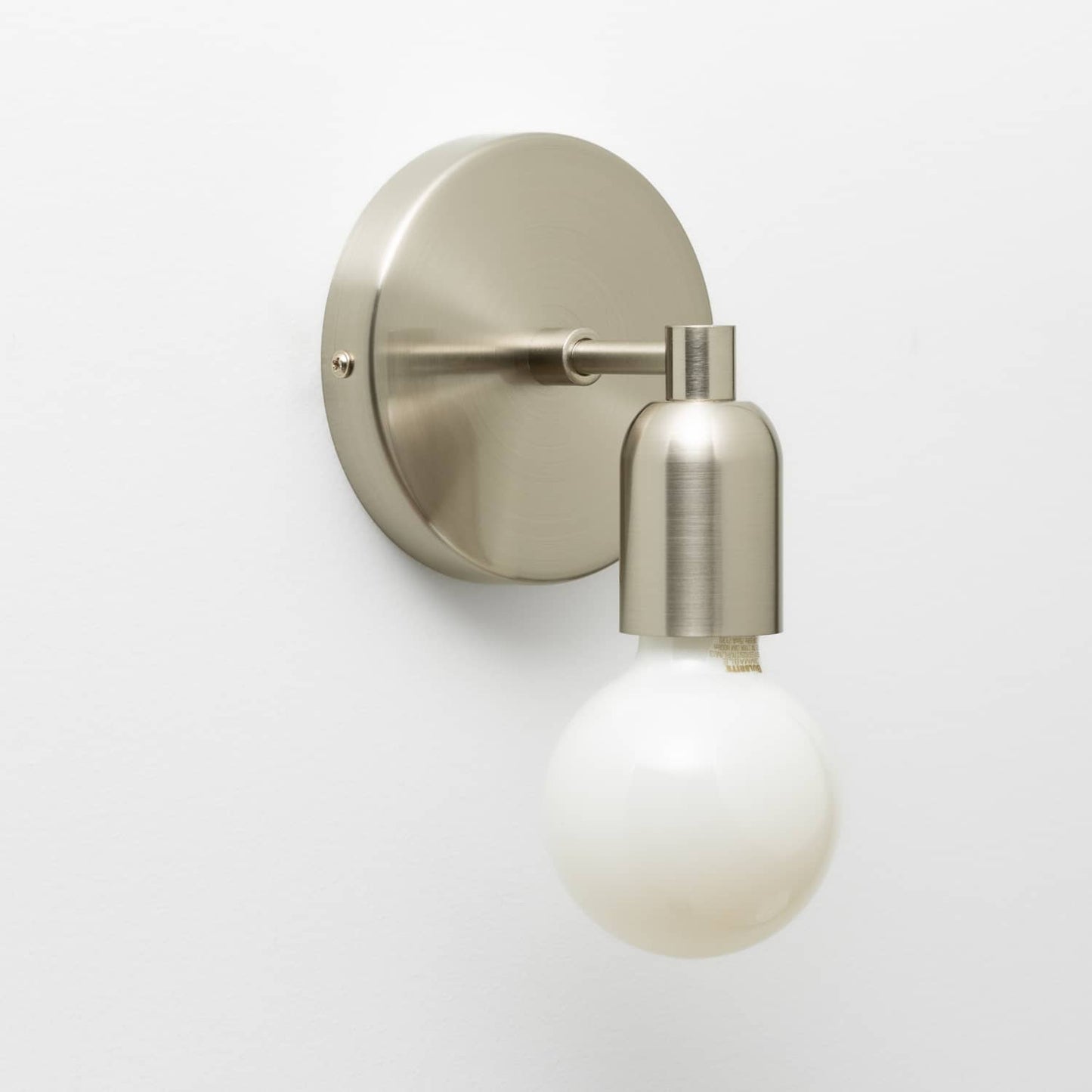 Junction Mini Solo Sconce in Brushed Nickel finish pictured with a G25 light bulb