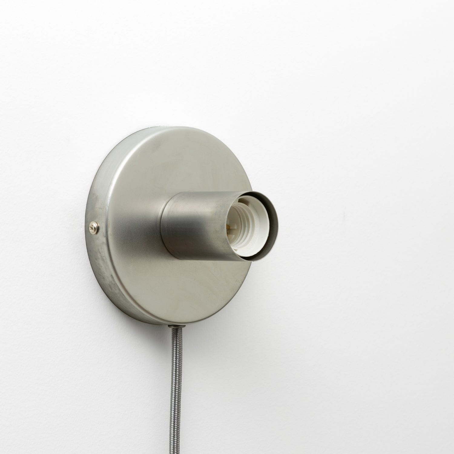 Button Plug-In Sconce in Raw Metal Finish