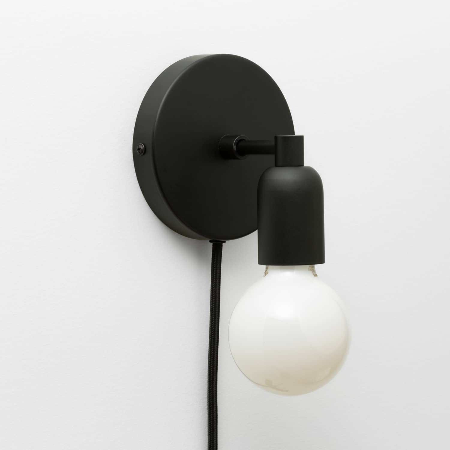 Junction Mini Solo Plug-In Sconce in Matte Black finish pictured with G25 light bulb