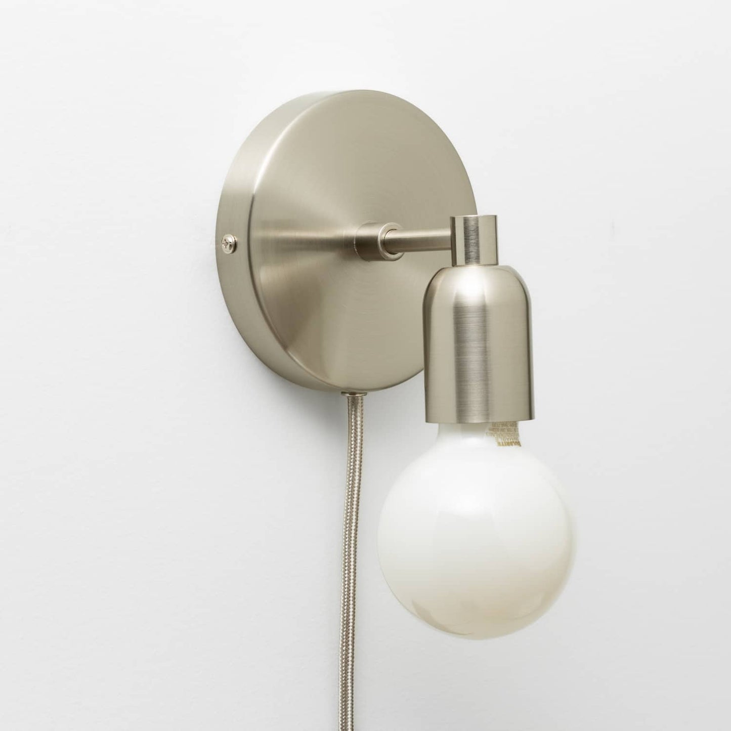Junction Mini Solo Plug-In Sconce in Brushed Nickel finish pictured with G25 light bulb