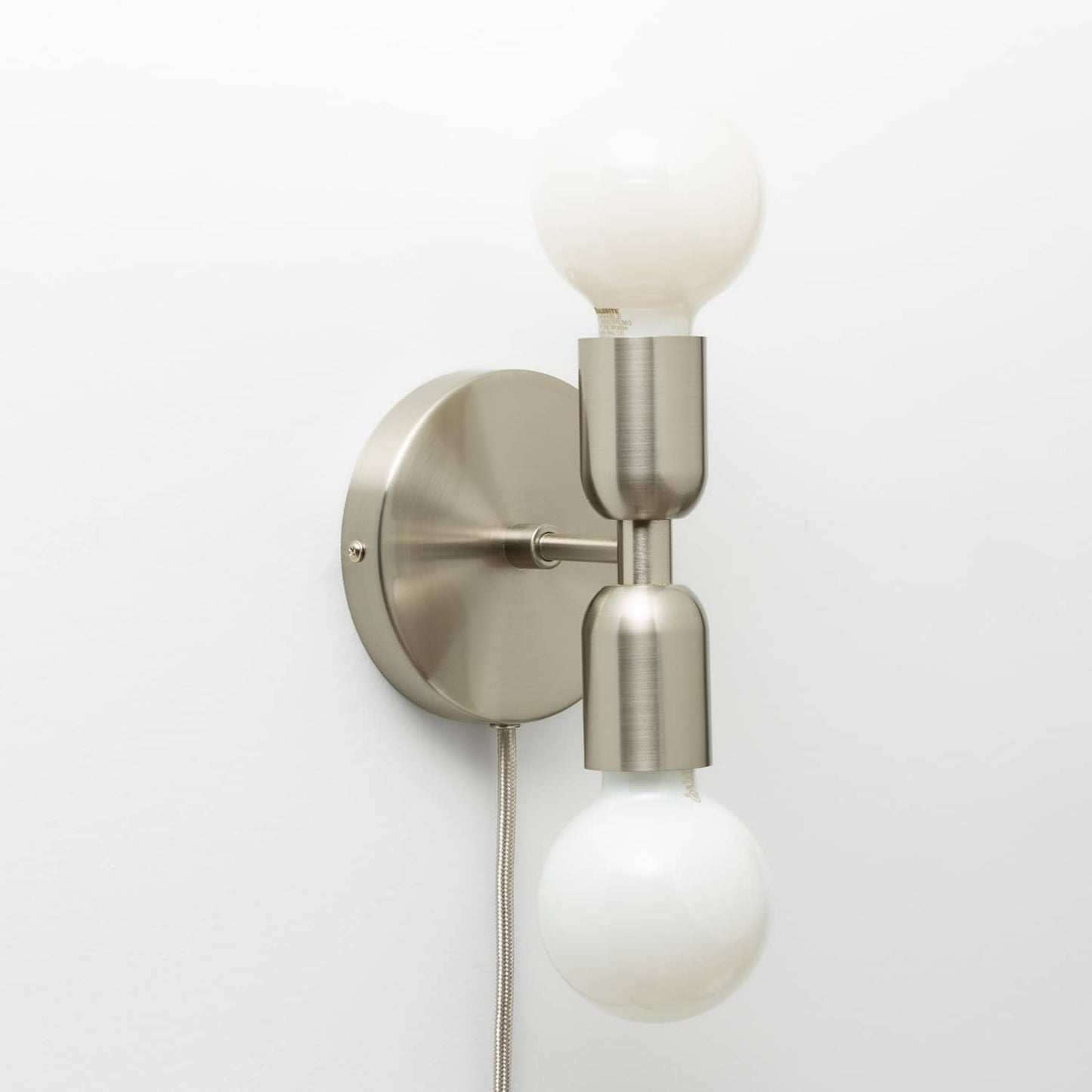 Junction Mini Duo Plug-In Sconce in Brushed Nickel finish with G25 milk glass light bulbs