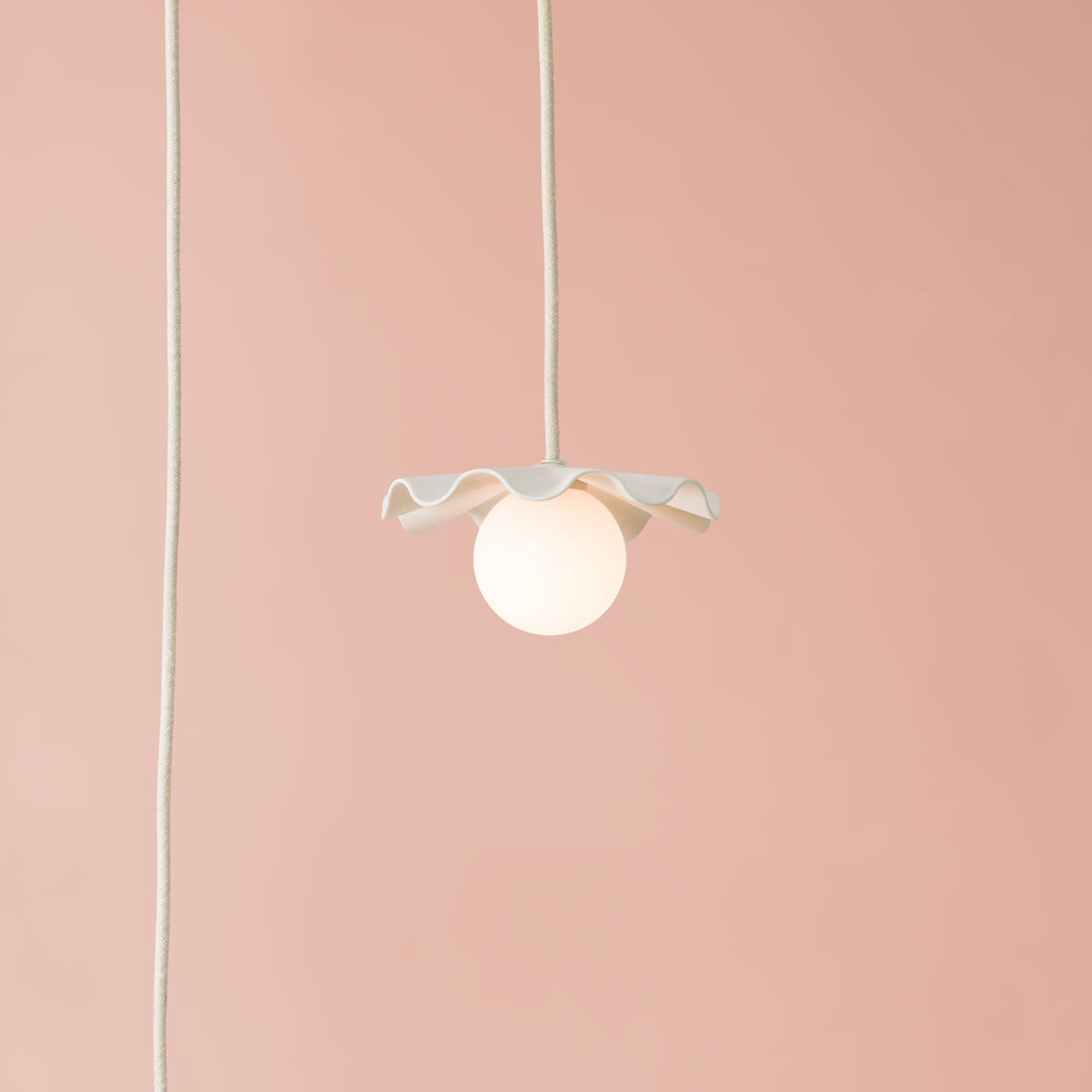 Fleur No. 1 plug-in porcelain mini pendant light with Linen cord and hardware in a home setting