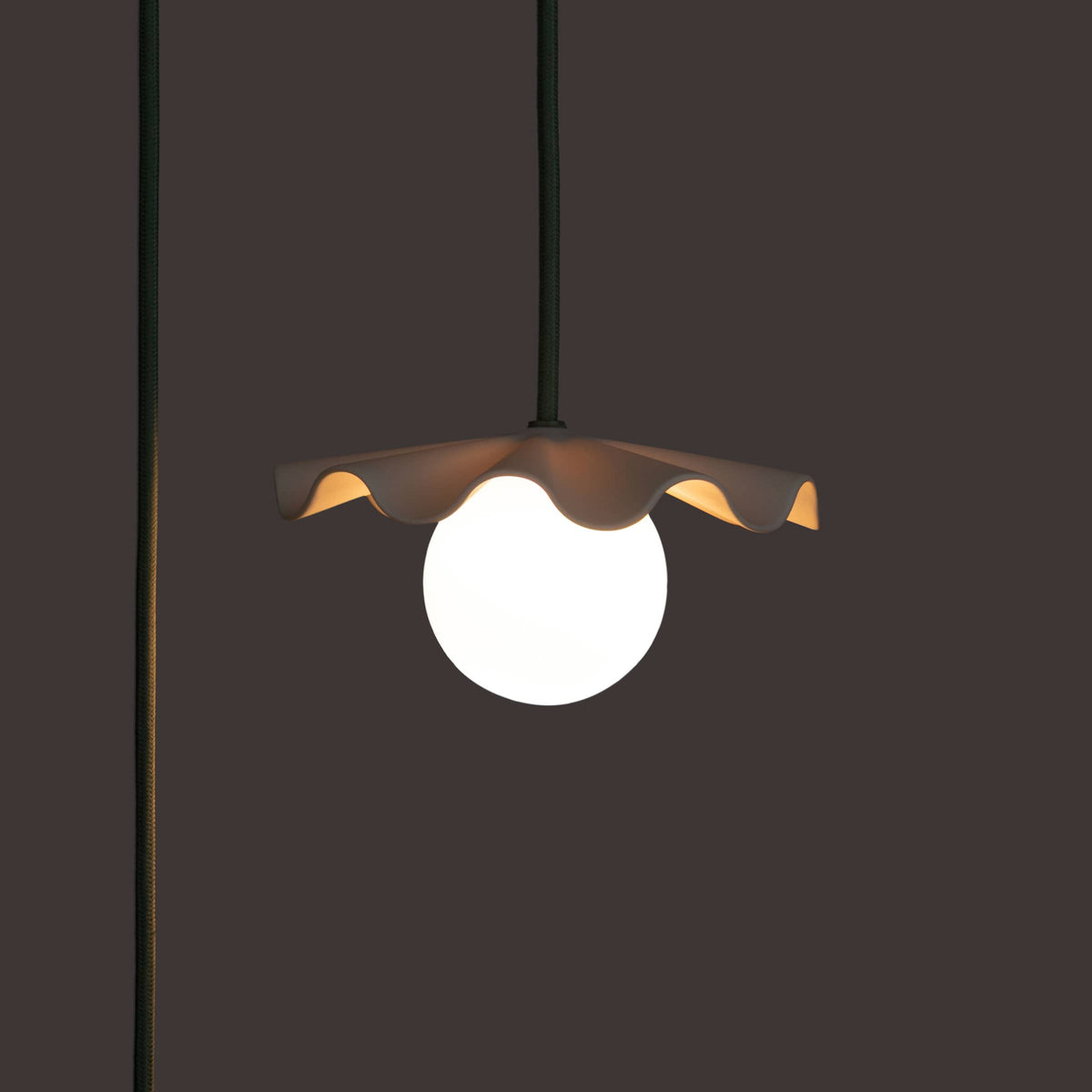 Fleur No. 1 plug-in porcelain mini pendant light with Sage cord and hardware in a home setting
