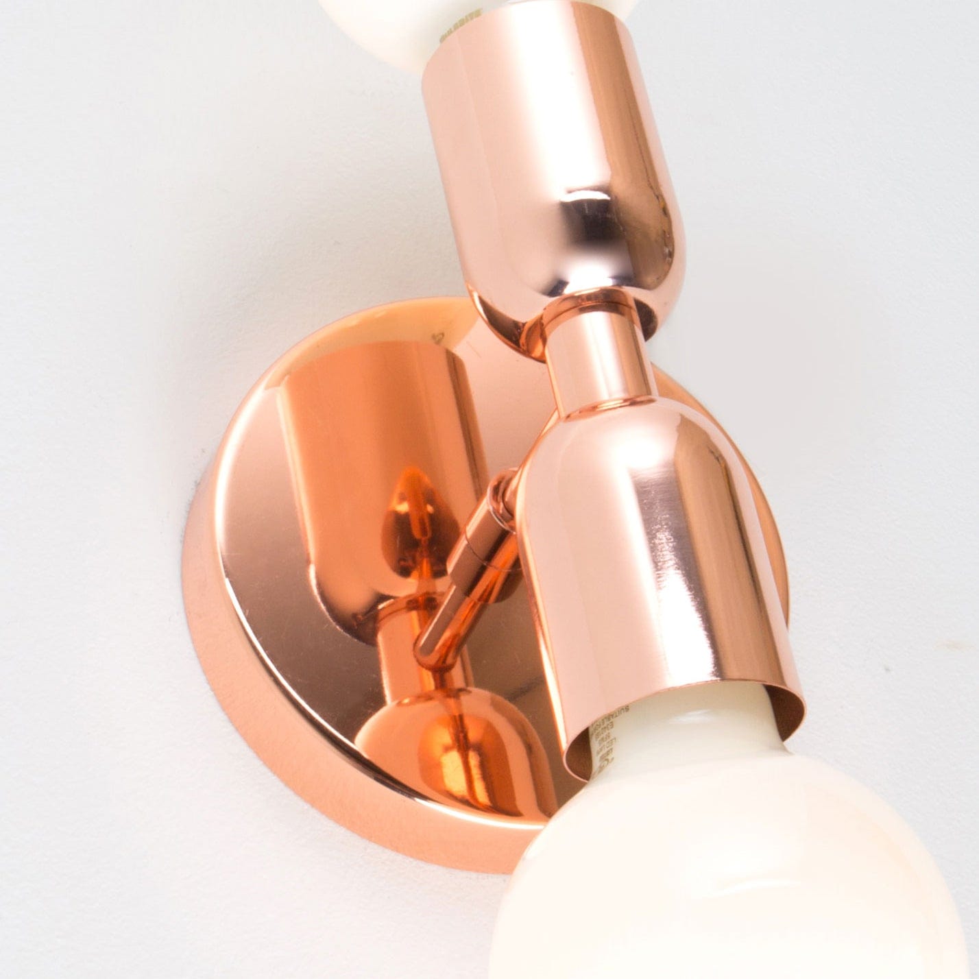 Close up photo of Junction Mini Duo Plug-In Sconce in Polished Copper finish