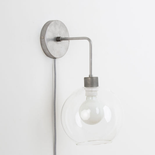Plug-In Bend Solo 8in Globe Sconce Raw Metal / Clear